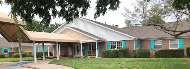 A cozy residential house with a well-maintained lawn and trees.