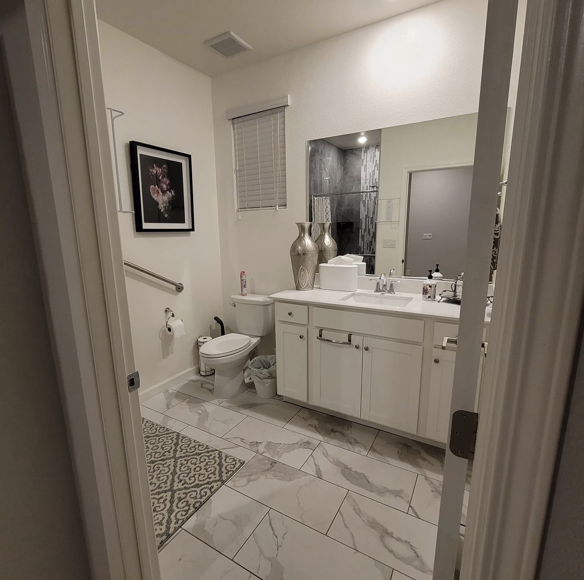 A modern bathroom interior with elegant decor and tiled flooring.
