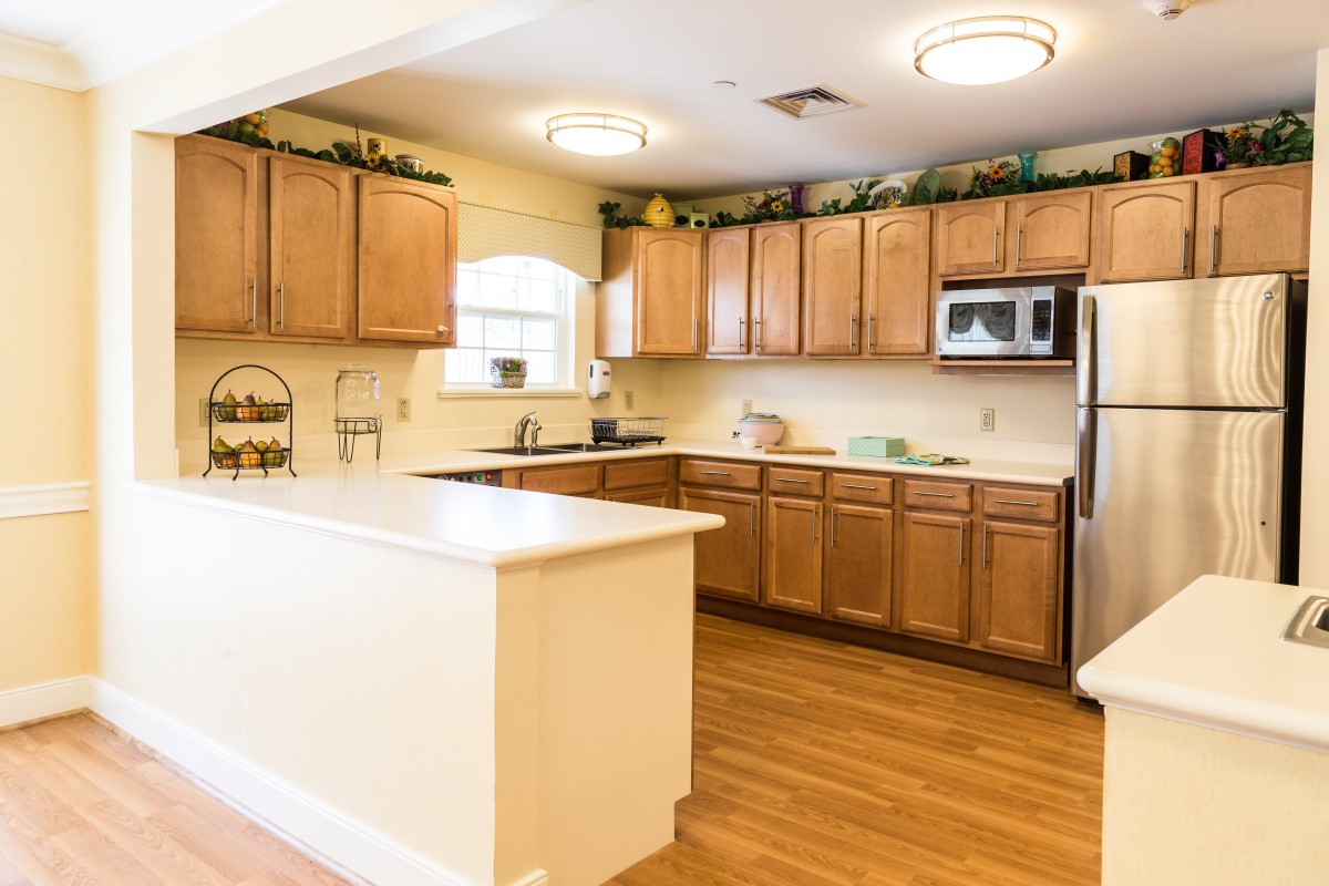 A well-lit kitchen with wooden cabinets and modern appliances.