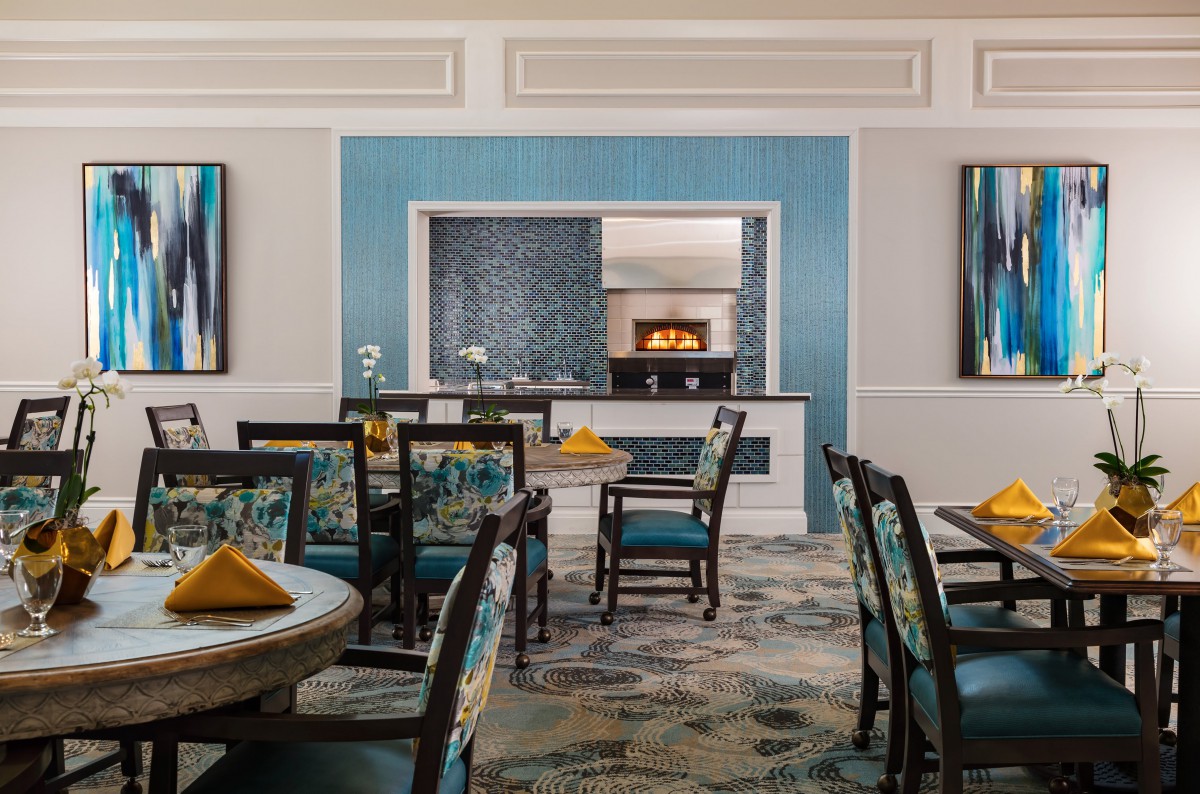 A stylish dining room with blue accents and elegant furnishings.