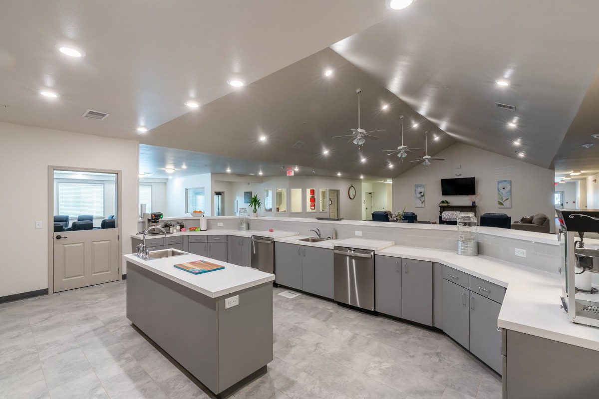 A spacious and modern kitchen interior with ample lighting.