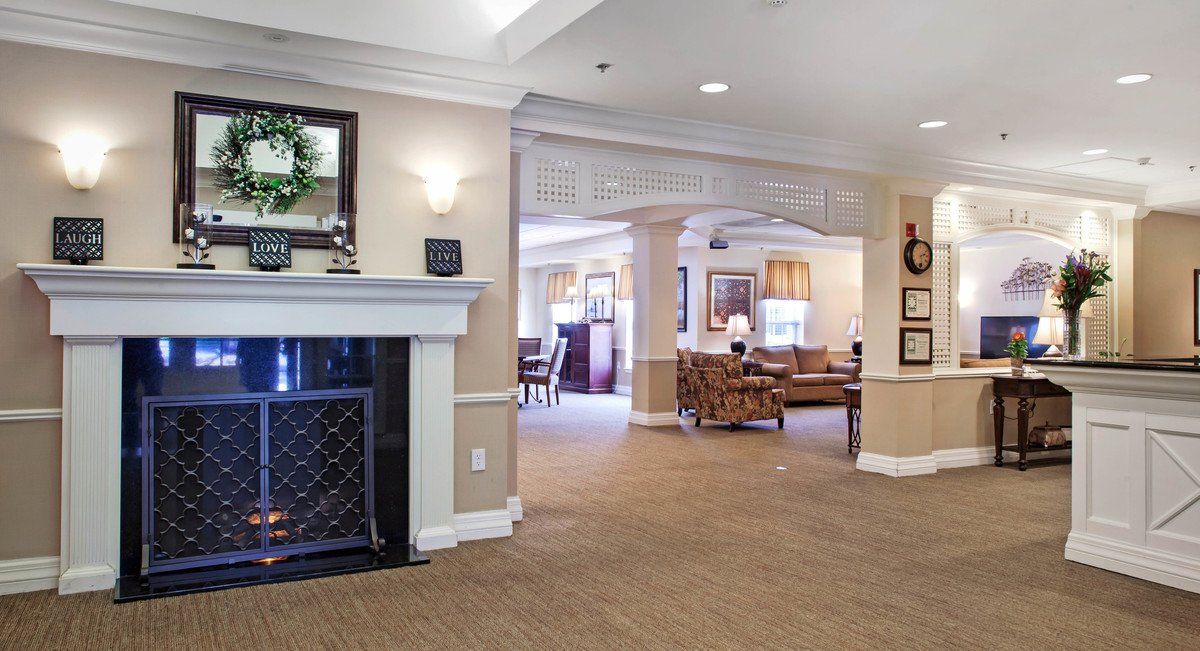 A cozy living room space with a fireplace and comfortable seating.