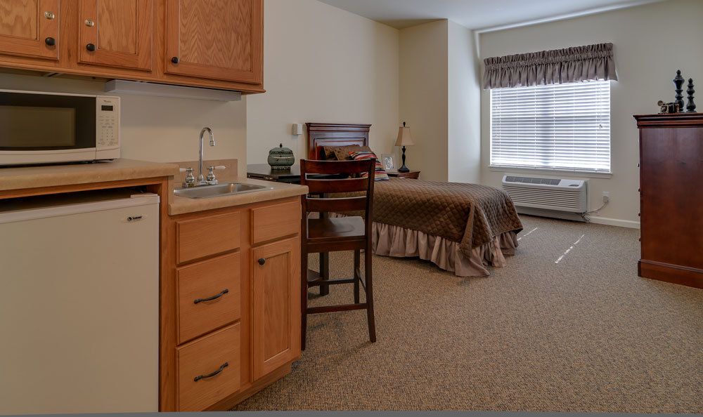 A cozy bedroom with a single bed, desk, and window.