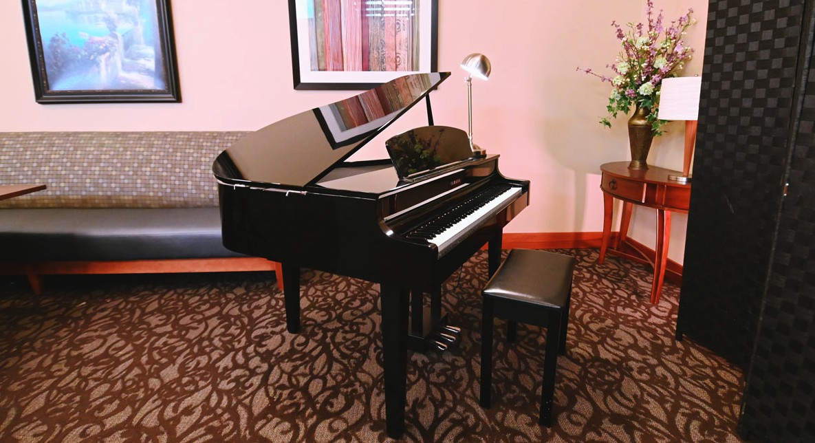 A grand piano in a well-decorated living room.