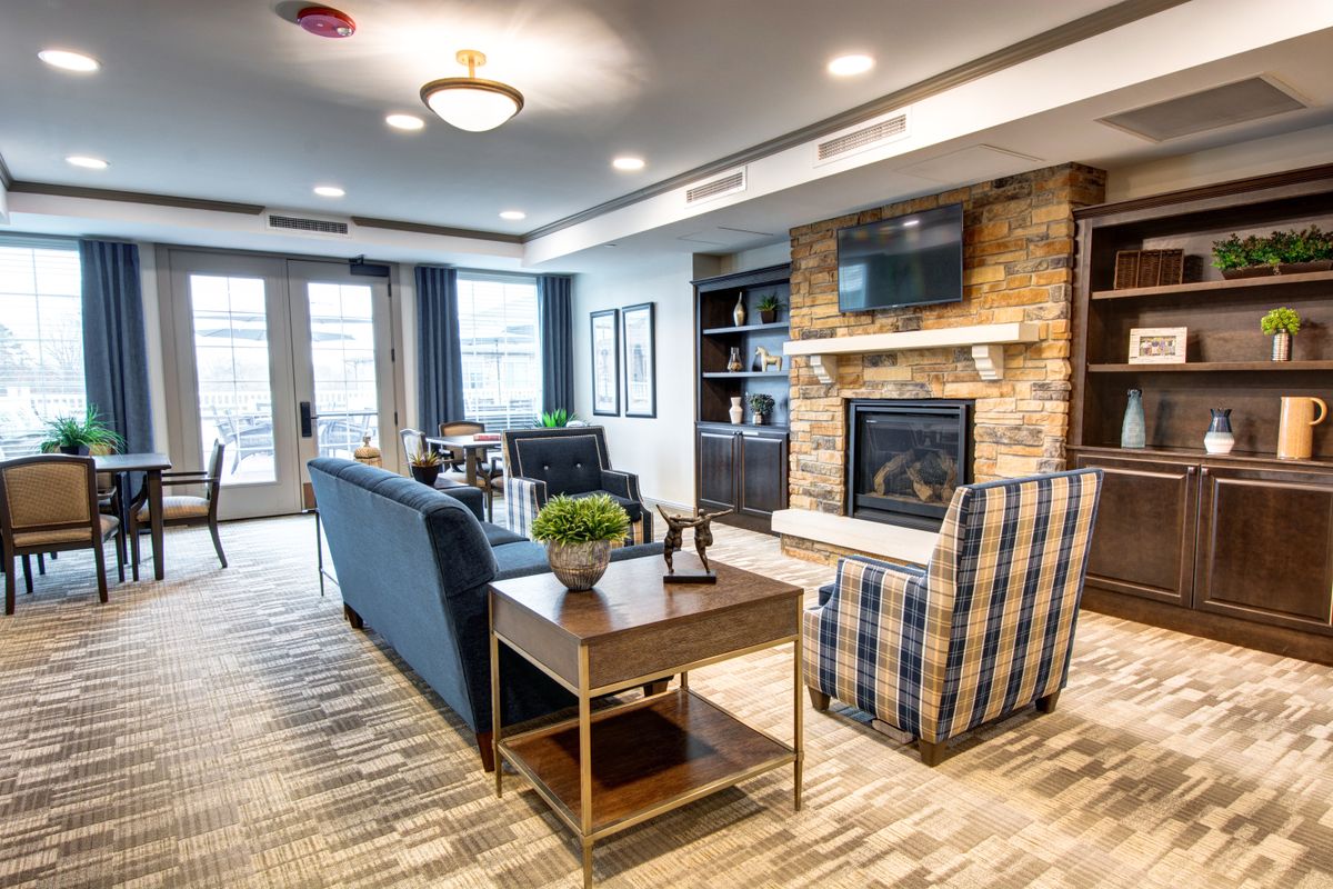 A cozy living room with a fireplace and comfortable seating.