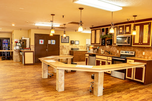 A spacious and well-equipped kitchen featuring modern appliances and a unique curved table design.
