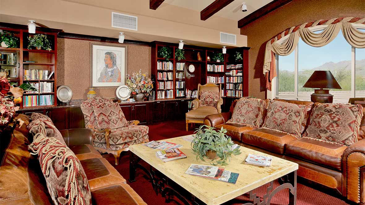 A cozy living room with elegant furniture and a well-stocked bookshelf.