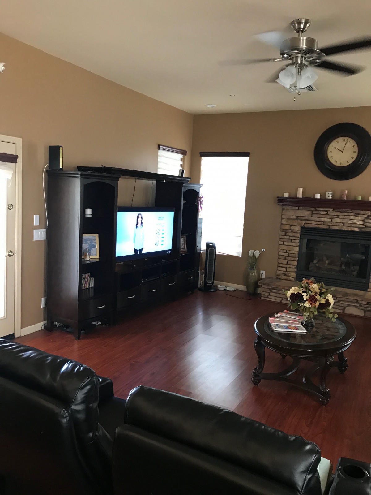 Cozy living room with a television and fireplace.