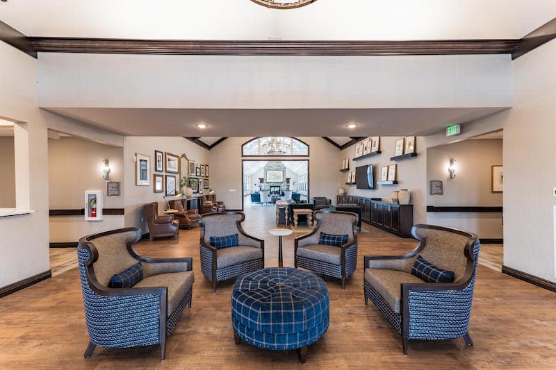 A modern lobby with a cozy seating arrangement featuring stylish chairs and decor.
