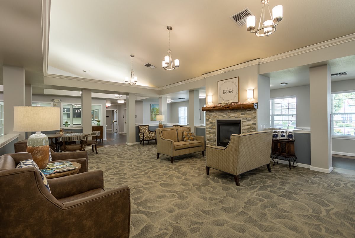 A spacious and modern lounge with comfortable seating and a fireplace.