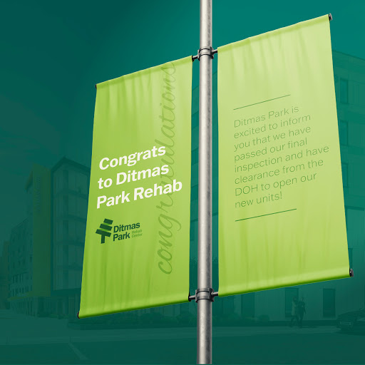 A green banner congratulating the completion of a park renovation.