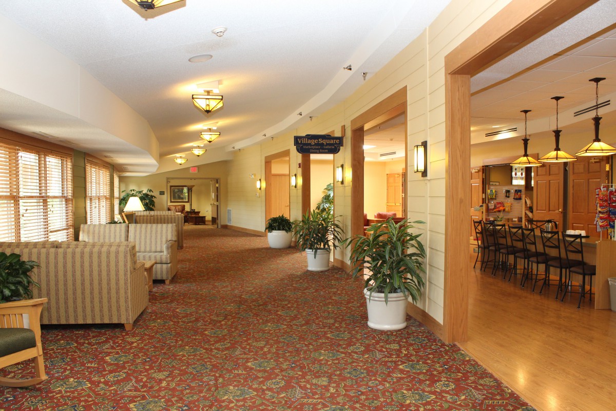 A spacious and well-lit lobby area with comfortable seating and decorative plants.