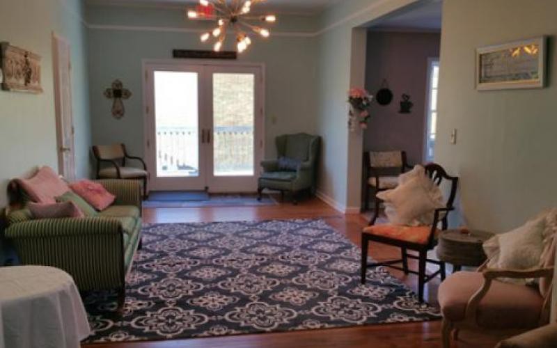A cozy living room with elegant furniture and a patterned rug.