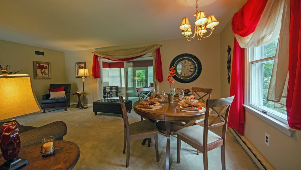 A cozy dining and living area with elegant decor and warm lighting.