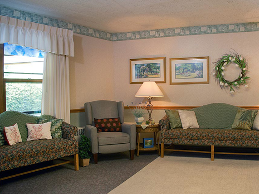 A cozy living room setup featuring comfortable seating and warm lighting.