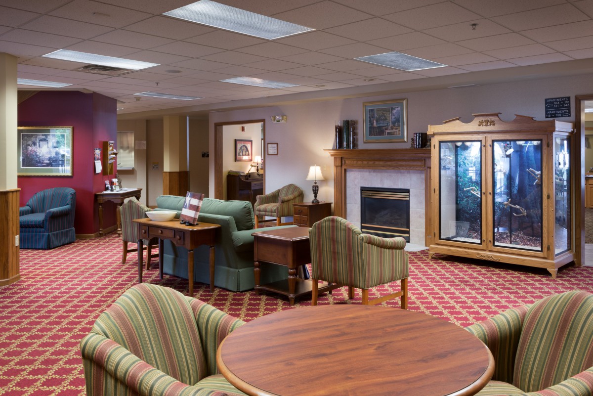 A cozy hotel lobby with comfortable seating, a fireplace, and elegant decor.