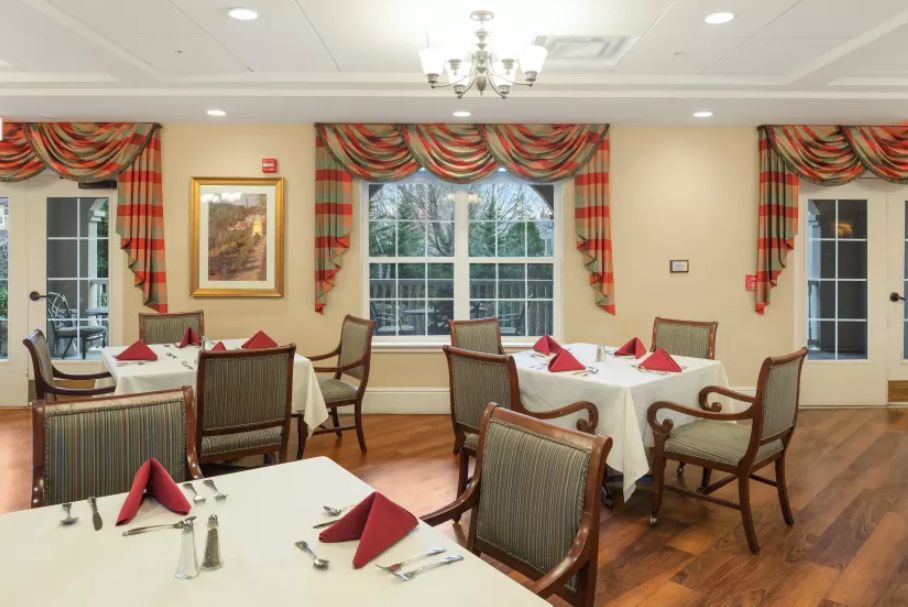A cozy dining area with elegantly set tables and a warm ambiance.