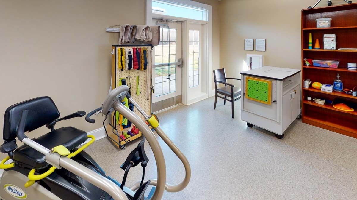 A therapy room equipped with exercise machines and tools for rehabilitation.