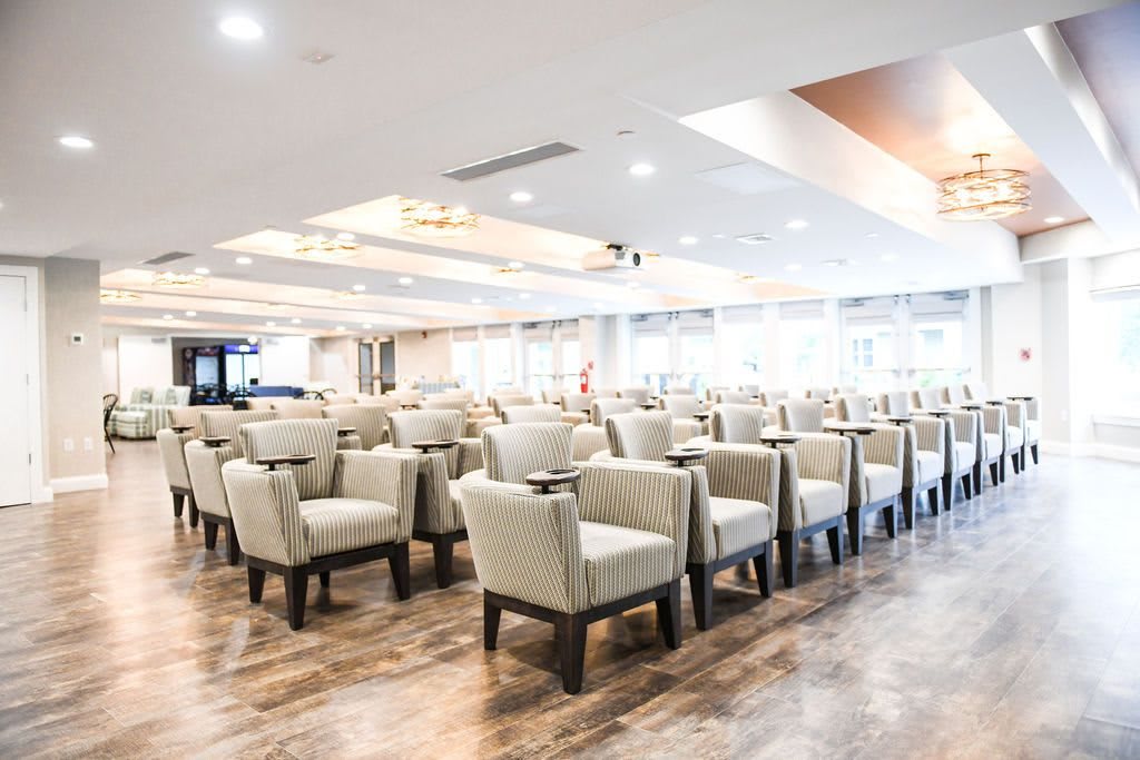 A spacious and modern conference room with arranged seating.
