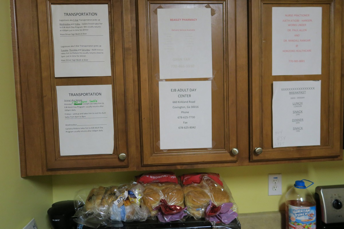 Kitchen cabinets with notices and bread on the countertop.