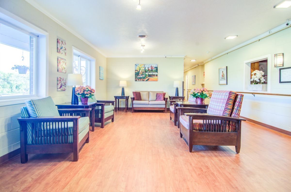 A spacious and well-lit living room with comfortable seating and elegant decor.