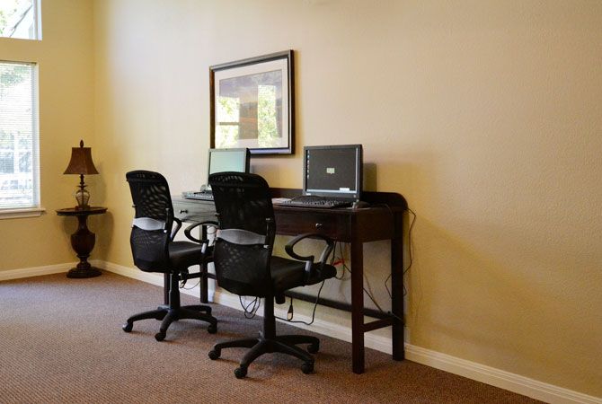 A small office workspace with two desks and computers.
