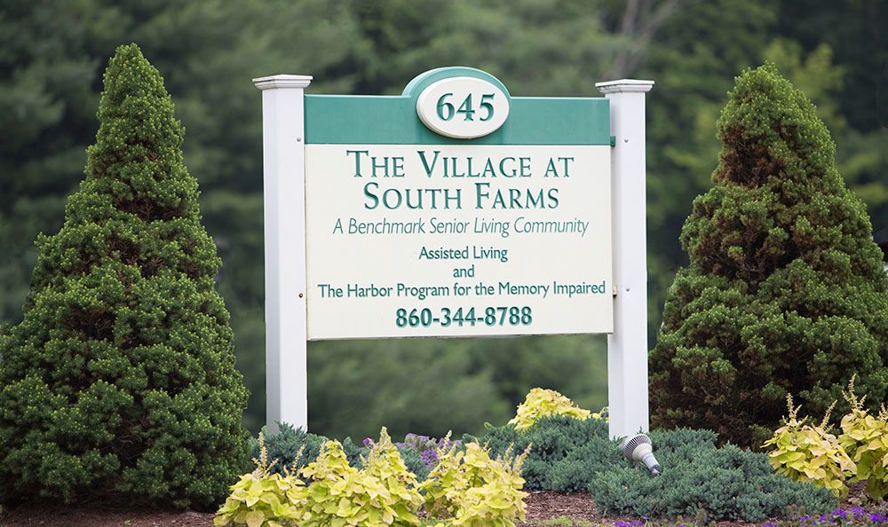 Sign for The Village at South Farms, a senior living community.