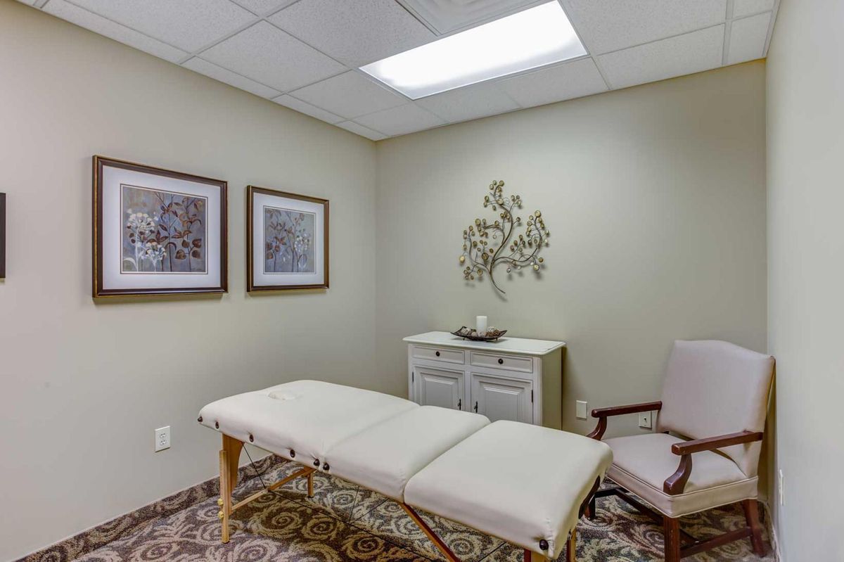A peaceful massage therapy room with a massage table and calming decor.