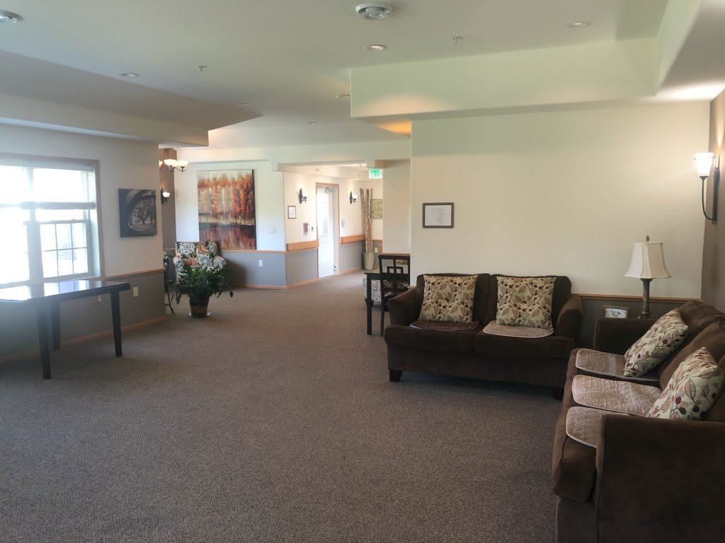 A spacious and well-lit lobby with comfortable seating and decorative elements.