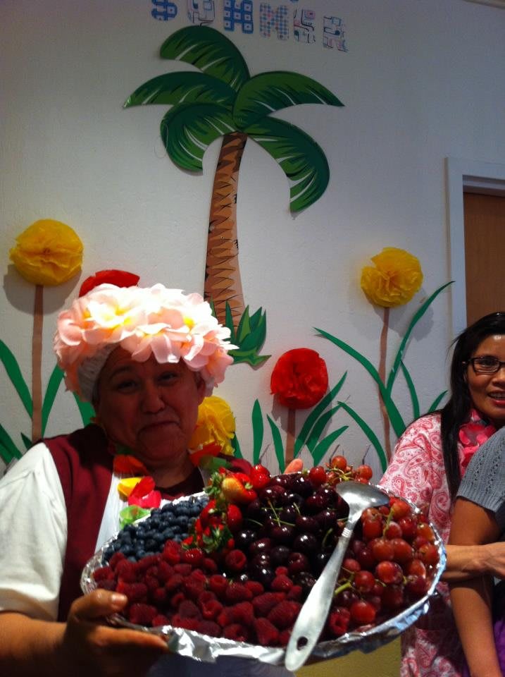 A festive gathering with colorful decorations and a basket of fruits.