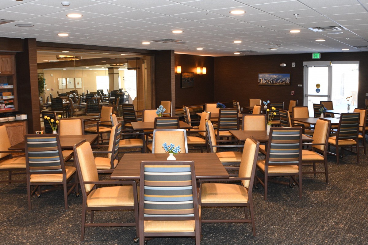 An empty dining area with neatly arranged tables and chairs, ready for guests.