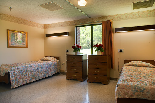A serene hospital room with two beds, offering a comforting environment.