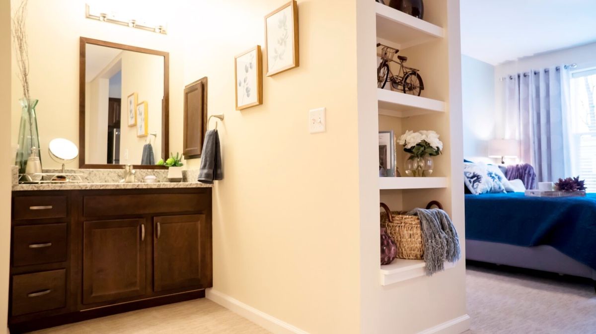 A well-organized bathroom with built-in shelves and neatly arranged decor.