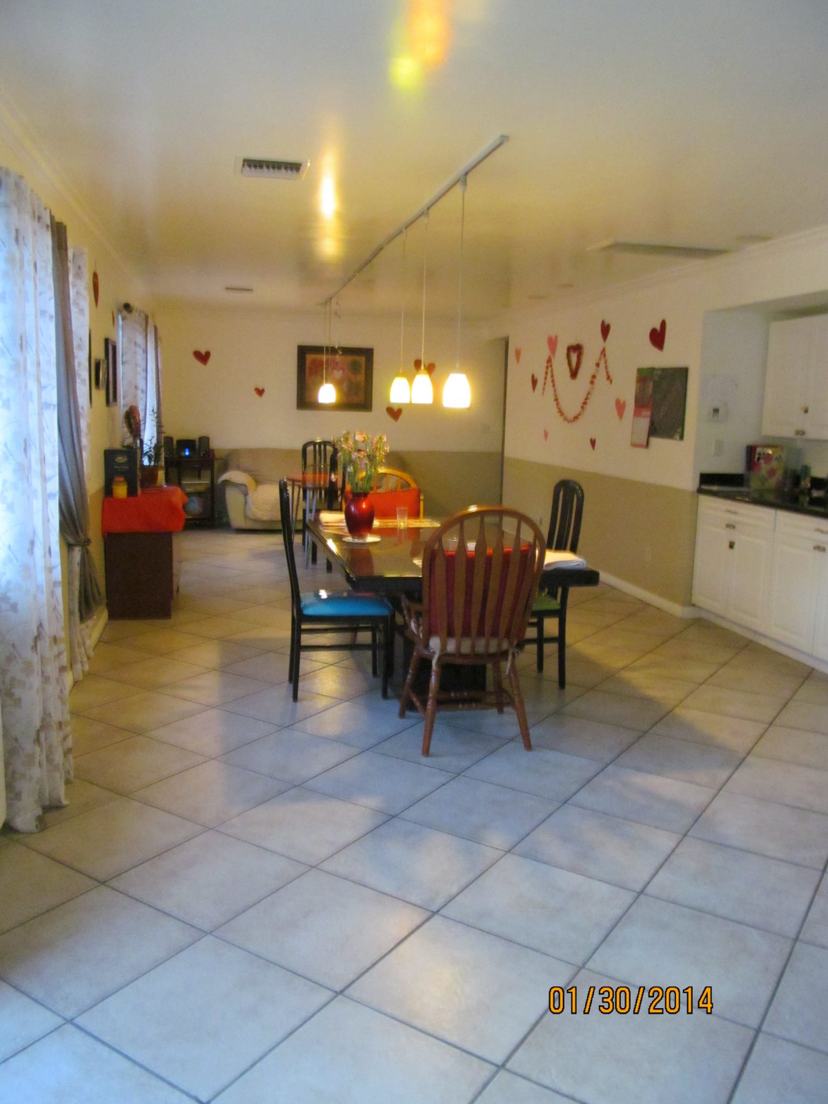 A cozy dining room with a table and chairs surrounded by decorations.