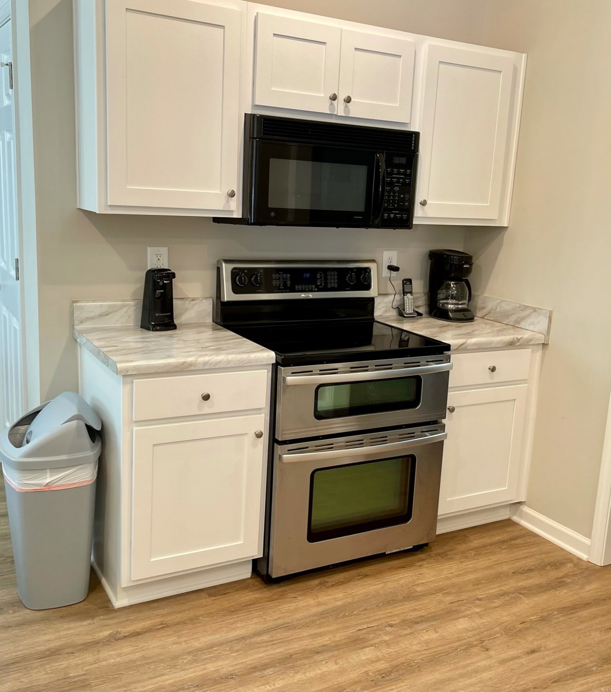 A modern kitchen setup with a stainless steel oven and microwave.