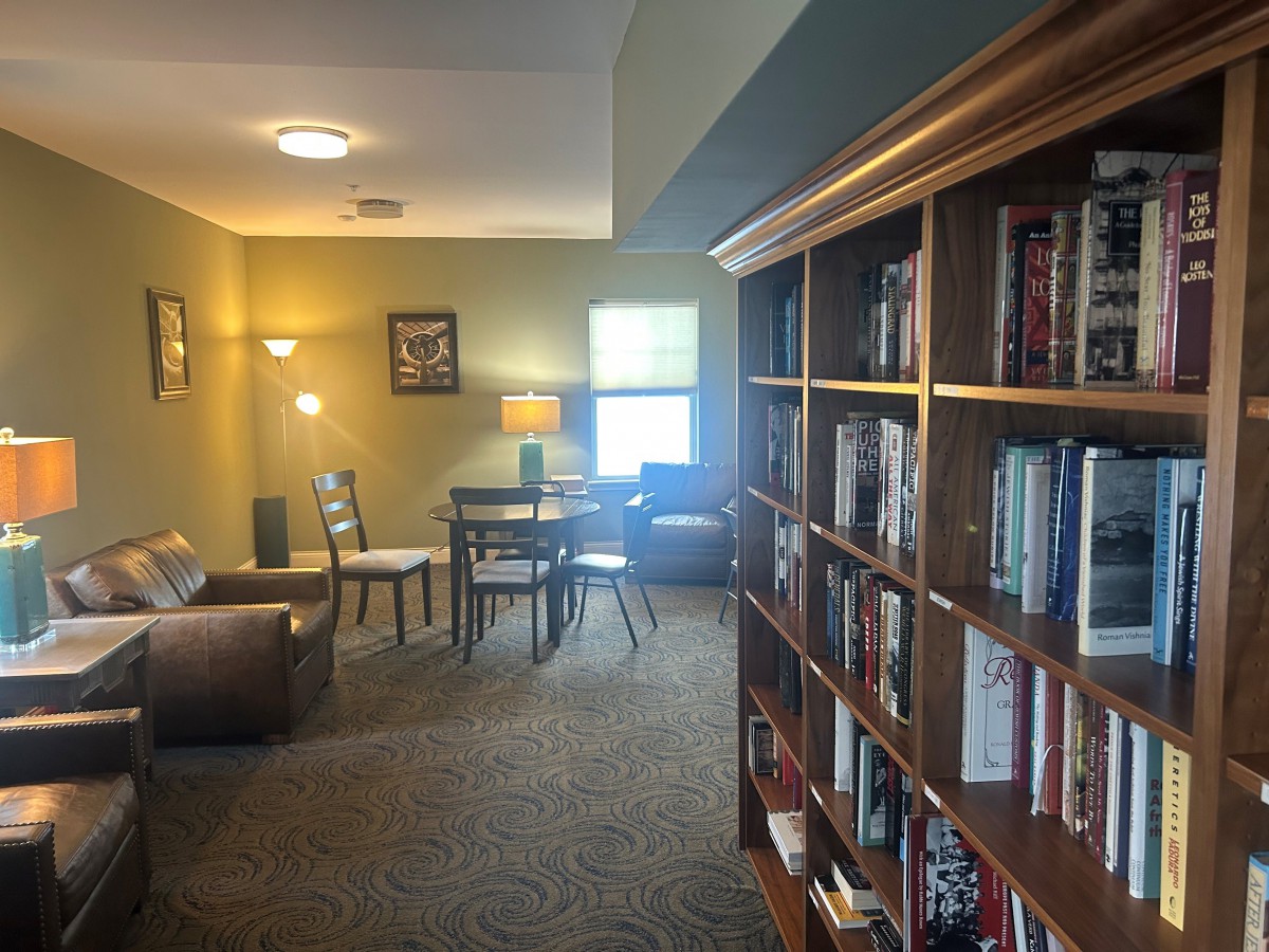A cozy library room with bookshelves and a reading area.
