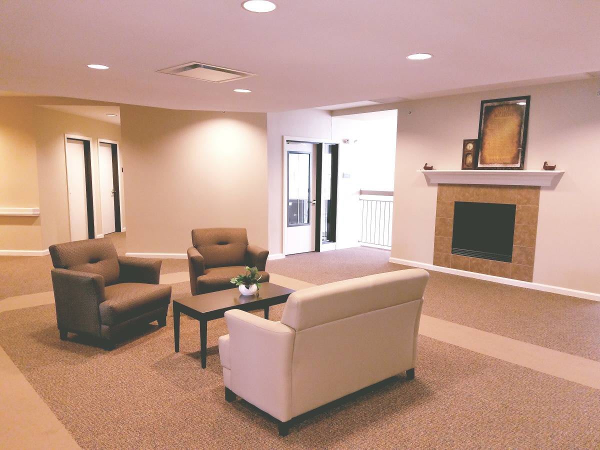 A modern living room with comfortable seating and a fireplace.