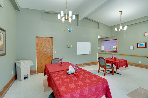 A cozy dining area featuring red tablecloths and a warm ambiance.