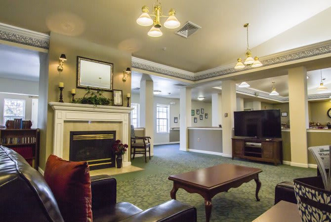 A cozy living room with a fireplace and comfortable seating.