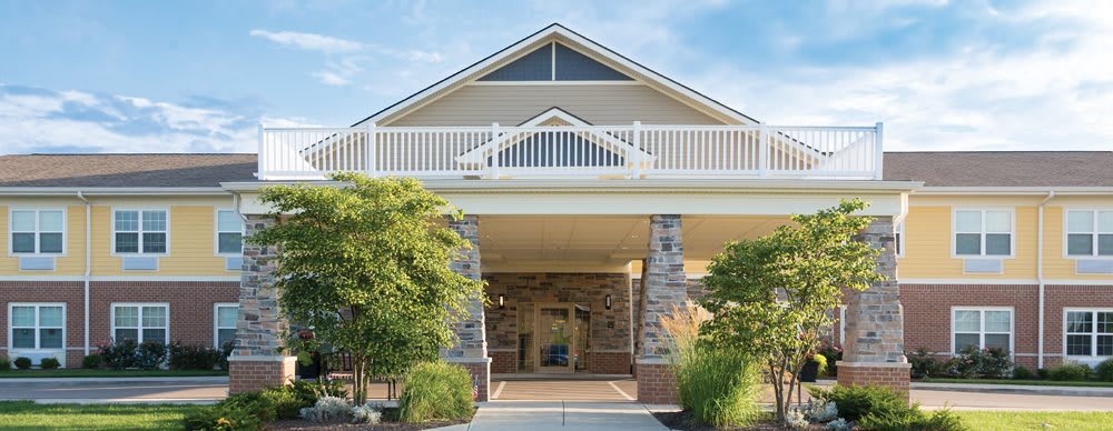 A modern residential house with stone pillars and a spacious porch.