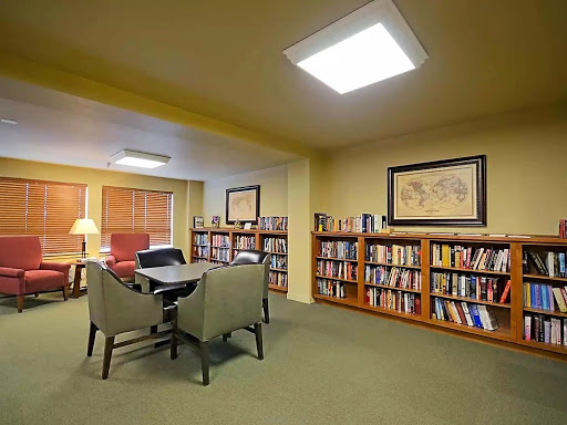 A cozy library corner featuring a collection of books and comfortable seating.