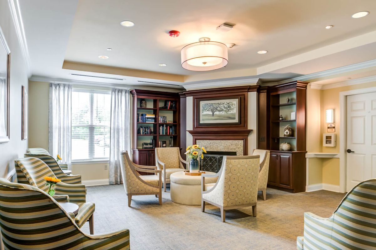 A cozy and modern living room with comfortable seating and built-in bookshelves surrounding a fireplace.