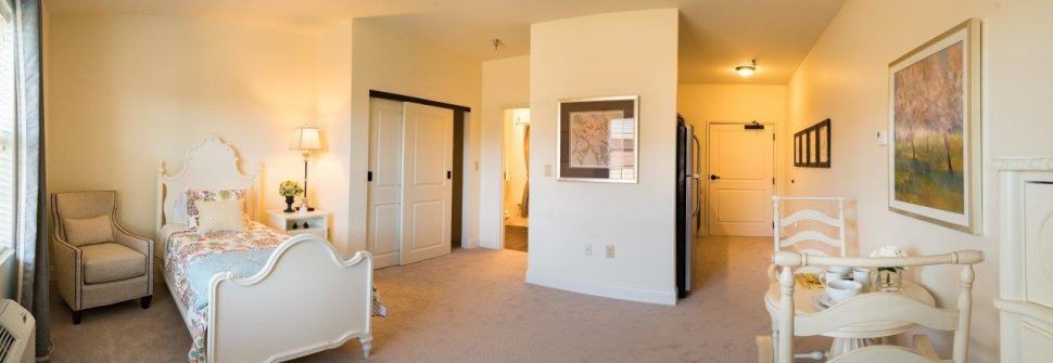 A cozy apartment interior with a carpeted floor, closet, and hallway.