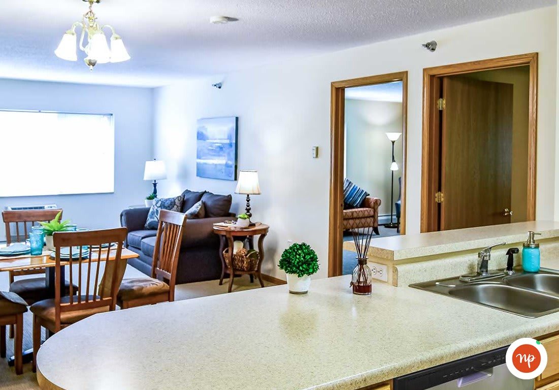 A cozy living space featuring a kitchen and dining area with stylish furniture and decor.