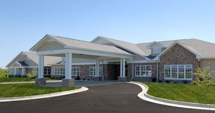 A modern building with a covered entrance and driveway.