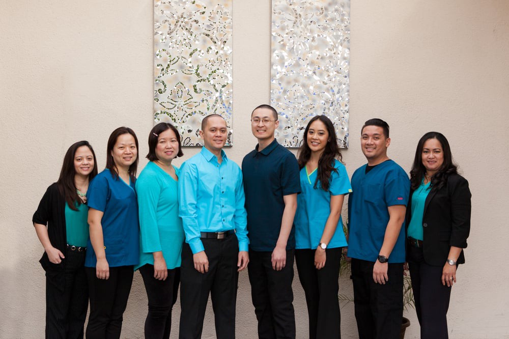 A group of professionals standing indoors, wearing coordinated uniforms.