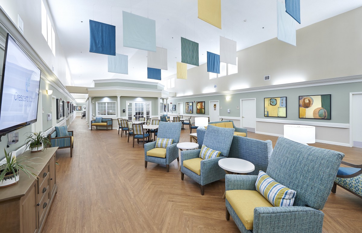 A modern lobby with comfortable seating and decorative ceiling panels.
