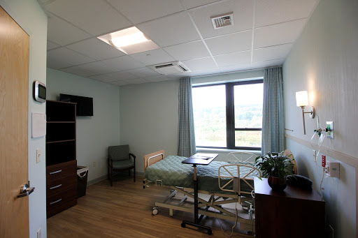 A bright and spacious hospital room designed for patient care.