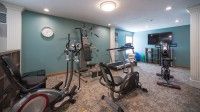 A small indoor gym equipped with various exercise machines and workout gear.