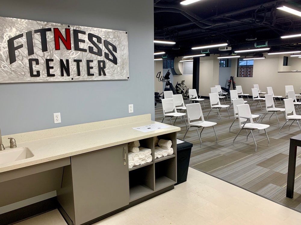 A view of a fitness center interior with rows of chairs and modern decor.